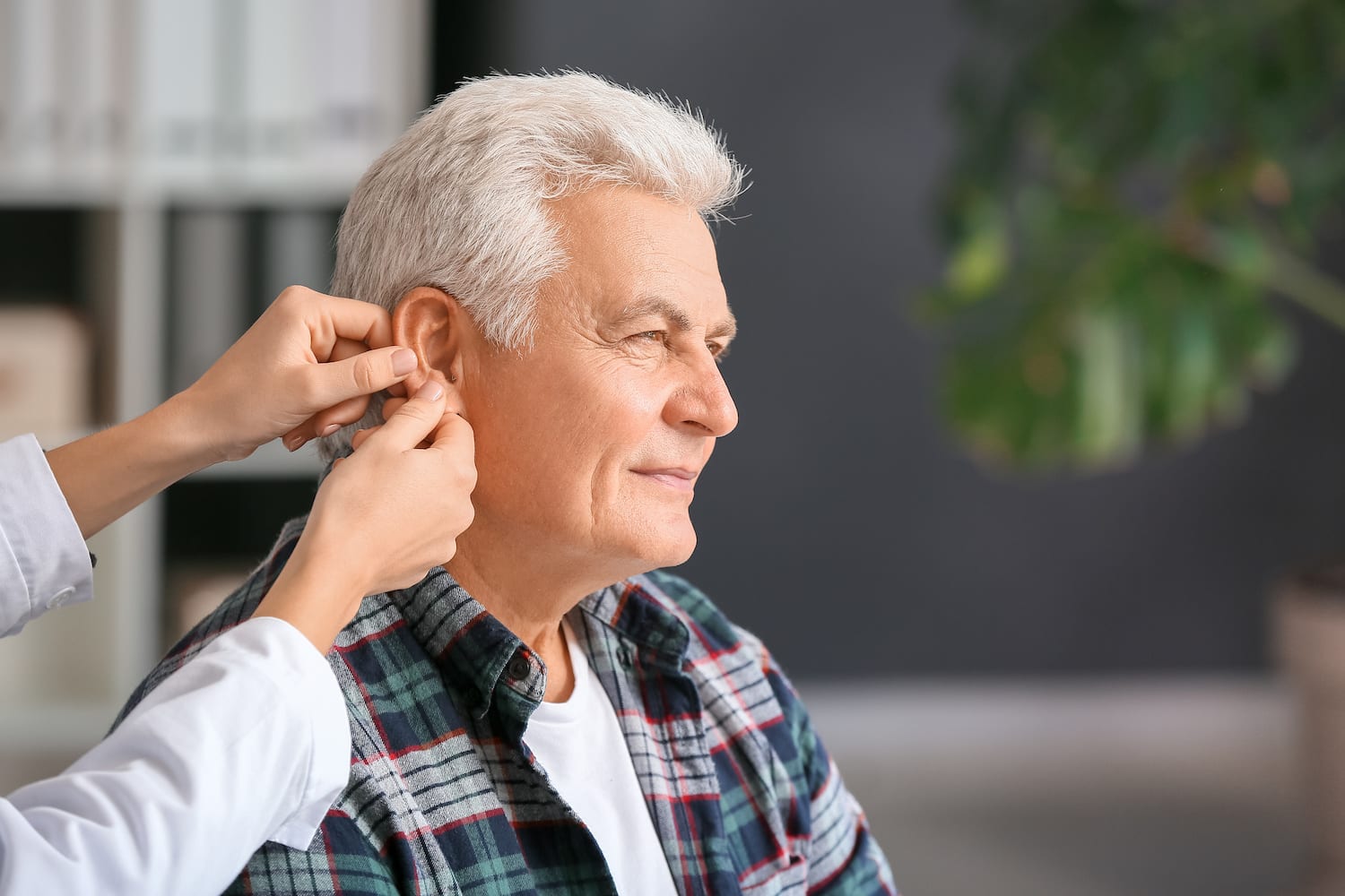 elderly man having his ears checked